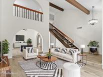 Bright living room featuring vaulted ceilings, wood beams, and an open floor plan at 2619 S Los Altos --, Mesa, AZ 85202