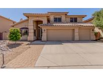 Charming two-story home with a three-car garage, arched entryway, and well-manicured landscaping at 5215 W Del Rio St, Chandler, AZ 85226