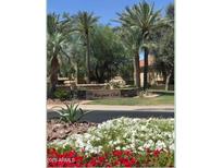 The Racquet Club community entrance features lush landscaping, mature palm trees and stone signage at 9708 E Via Linda -- # 1338, Scottsdale, AZ 85258
