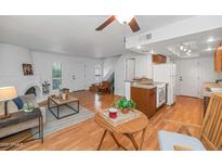 Bright living room boasts a fireplace, wood floors, and an open floor plan flowing into the kitchen at 1826 E Frier Dr # 2, Phoenix, AZ 85020