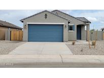 Charming single-Gathering home with a blue garage door, a paved driveway, and desert landscaping at 2680 E Santa Rosalia Dr, Casa Grande, AZ 85194