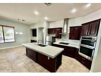 A spacious kitchen with a large island and updated, stainless steel appliances and plenty of storage space at 702 E Capricorn Way, Chandler, AZ 85249