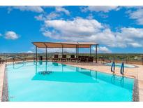 Rooftop pool and patio area with shade structure and seating boasting city and mountain views at 7175 E Camelback Rd # 109, Scottsdale, AZ 85251