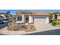 Charming home with a desert landscape and a tile roof, complemented by a two-car garage and inviting entrance at 1226 E Presidio Rd, Phoenix, AZ 85022