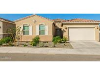 Charming single-story home with neutral stucco, tiled roof, two-car garage, and low-maintenance desert landscaping at 13618 W Phacelia Ln, Peoria, AZ 85383