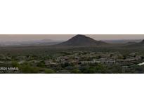 Panoramic view of a desert mountain range with houses below at 15025 E Scarlet Sky Ln # 1, Fountain Hills, AZ 85268