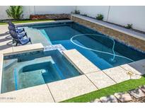 Inviting pool and spa area with modern landscaping, perfect for relaxation and entertaining at 19511 N 76Th Ave, Glendale, AZ 85308