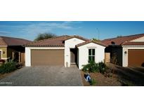 Charming single-story home with a well-manicured front yard and a brick paved driveway at 1972 N Loretta Pl, Casa Grande, AZ 85122