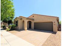 Inviting single-story home with a two-car garage and a well-manicured front yard in a desirable neighborhood at 3085 E Patrick St, Gilbert, AZ 85295