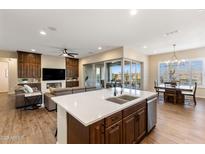 Open-concept kitchen with a spacious island, modern appliances, and seamless access to the outdoor patio at 32237 N 133Rd Dr, Peoria, AZ 85383