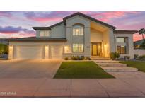 Elegant two-story home with a well-manicured lawn, three-car garage, and a stylish front entrance at 3623 S Agave Way, Chandler, AZ 85248