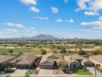 Beautiful aerial view of a community with golf course and mountain backdrop on a sunny day, Arizona real estate at 3933 E Meadowview Dr, Gilbert, AZ 85298