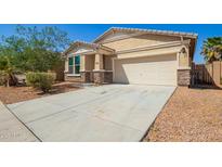 Charming single-Gathering home with a well-manicured lawn, desert landscaping, and attached two-car garage at 40800 W Rio Grande Dr, Maricopa, AZ 85138