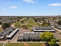 Scenic aerial view of townhomes near a lush golf course, perfect for relaxation and recreation at 418 E Woodman Dr, Tempe, AZ 85283