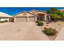 Inviting single Gathering home with a three car garage and low maintenance desert landscaping at 632 W Natal Cir, Mesa, AZ 85210