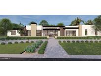 Stunning modern home boasts clean lines, stone accents, and lush landscaping for optimal curb appeal at 7001 E Paradise Dr, Scottsdale, AZ 85254