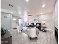 Spacious living room with contemporary decor, a ceiling fan, and easy access to the patio at 850 S River Dr # 1085, Tempe, AZ 85281