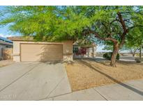 Charming single-story home with a well-manicured desert landscape and a two-car garage at 89 S 151St Ave, Goodyear, AZ 85338