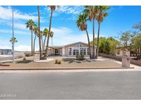 Charming home with beautiful palm trees, easy-care gravel landscaping, and a welcoming facade at 9349 E Navajo Pl, Sun Lakes, AZ 85248