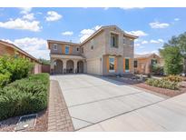 Stunning two-story home featuring a long driveway, desert landscaping, and charming arched front porch at 10417 W Alyssa Ln, Peoria, AZ 85383