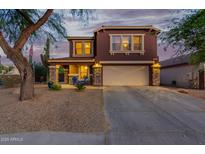 Charming two-story home with a spacious driveway and a well-maintained front yard with desert landscaping at 10561 E Plata Ave, Mesa, AZ 85212