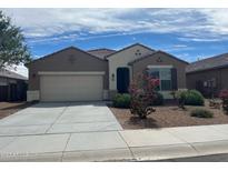 Charming single-story home featuring a two-car garage and a landscaped front yard with decorative rock at 13549 W Paso Trl, Peoria, AZ 85383