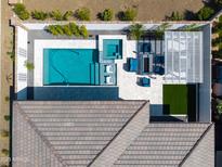 Aerial view of a private backyard featuring a modern pool, spa, and covered patio area with stylish outdoor furniture at 17710 W Guthrie St, Surprise, AZ 85388