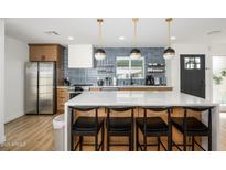 Modern kitchen featuring stainless steel appliances, white countertops, and stylish pendant lighting at 2044 N 71St St, Scottsdale, AZ 85257