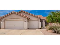 Charming single-story home with a two-car garage and low-maintenance desert landscaping at 22026 N 44Th Pl, Phoenix, AZ 85050