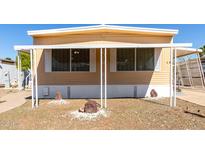 Cozy home with a charming porch featuring decorative white columns and well-maintained gravel landscaping at 2650 W Union Hills Dr # 131, Phoenix, AZ 85027