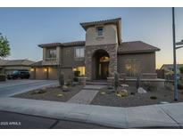Beautiful two-story home featuring a three car garage and a stone archway at 27316 N Covered Wagon Rd, Phoenix, AZ 85085