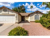 Inviting single-story home with a well-maintained yard, two-car garage, and desert landscaping at 4102 W Fallen Leaf Ln, Glendale, AZ 85310