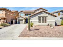 Charming two-story home with desert landscaping and a spacious driveway leading to a three-car garage at 44314 W Mescal St, Maricopa, AZ 85138