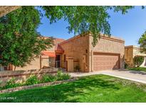 Charming single-story home with a well-maintained front yard and two-car garage at 563 N Spanish Springs Dr, Chandler, AZ 85226