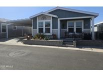 Charming single-story home featuring a cozy front porch, carport, and landscaped garden bed at 650 N Hawes Rd # 3123, Mesa, AZ 85207
