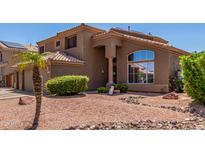 Charming two-story home featuring a well-maintained yard and neutral-toned exterior at 7103 E Medina Ave, Mesa, AZ 85209
