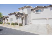Inviting two-story home with stucco siding, well-kept landscaping, and an attached two-car garage at 7978 W Zoe Ella Way, Peoria, AZ 85382