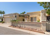 Inviting home with desert landscaping, a covered entryway, and a charming exterior paint scheme at 9012 S 47Th Pl, Phoenix, AZ 85044