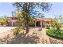 Charming home boasts a tile roof, xeriscaped front yard and mature landscaping at 1305 Coyote Pass Pass, Carefree, AZ 85377