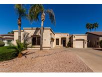 Charming single-story home featuring a three-car garage and desert landscaping at 1865 S Morrison Ln, Gilbert, AZ 85295