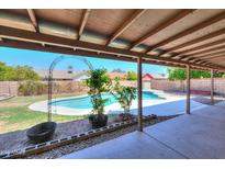 Inviting pool area with a covered patio, perfect for outdoor relaxation and entertainment at 2322 E Dolphin Ave, Mesa, AZ 85204