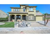 Two-story home with stone accents, tile roof, and arched entry offers an inviting facade at 248 S 167Th Dr, Goodyear, AZ 85338