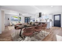 Bright dining room features stylish table, seating, and easy access to the kitchen and living room at 3231 W Willow Ave, Phoenix, AZ 85029