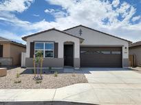 Charming single-story home featuring a two-car garage and low-maintenance desert landscaping at 37111 W Prado St, Maricopa, AZ 85138