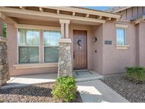 Inviting front entrance featuring a stone pillar, a wreath-adorned front door, and a well-maintained landscape at 4646 E Maplewood St, Gilbert, AZ 85297