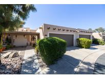 Charming exterior of the home with mature landscaping, a two car garage and a private entry at 6526 N 13Th Dr, Phoenix, AZ 85013