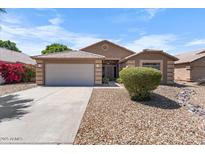 Charming single-story home showcasing a two-car garage and easy-care desert landscaping at 7778 N 51St Ln, Glendale, AZ 85301