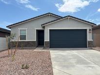 Charming single-story home features a two-car garage and low maintenance front yard at 17425 W Eva St, Waddell, AZ 85355