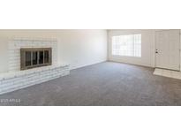 Spacious living room featuring a fireplace and a front door entrance at 2515 S Maple Ave # 104, Tempe, AZ 85282