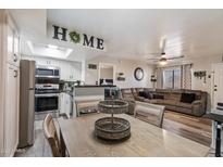 Open-concept living space showcasing the kitchen, dining area, and comfortable living room at 3535 W Tierra Buena Ln # 256, Phoenix, AZ 85053